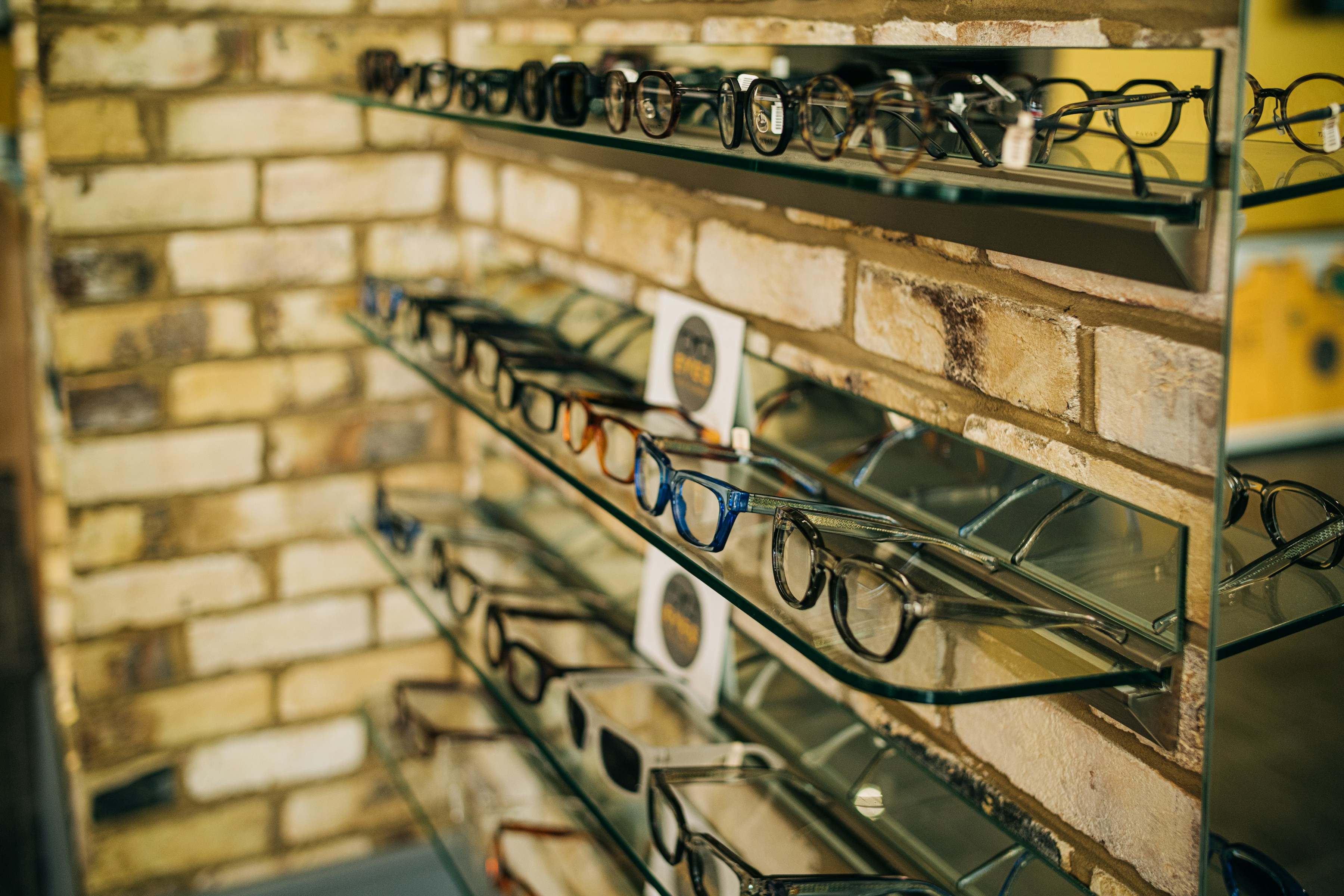 Spectacle frames on glass shelves in the shop