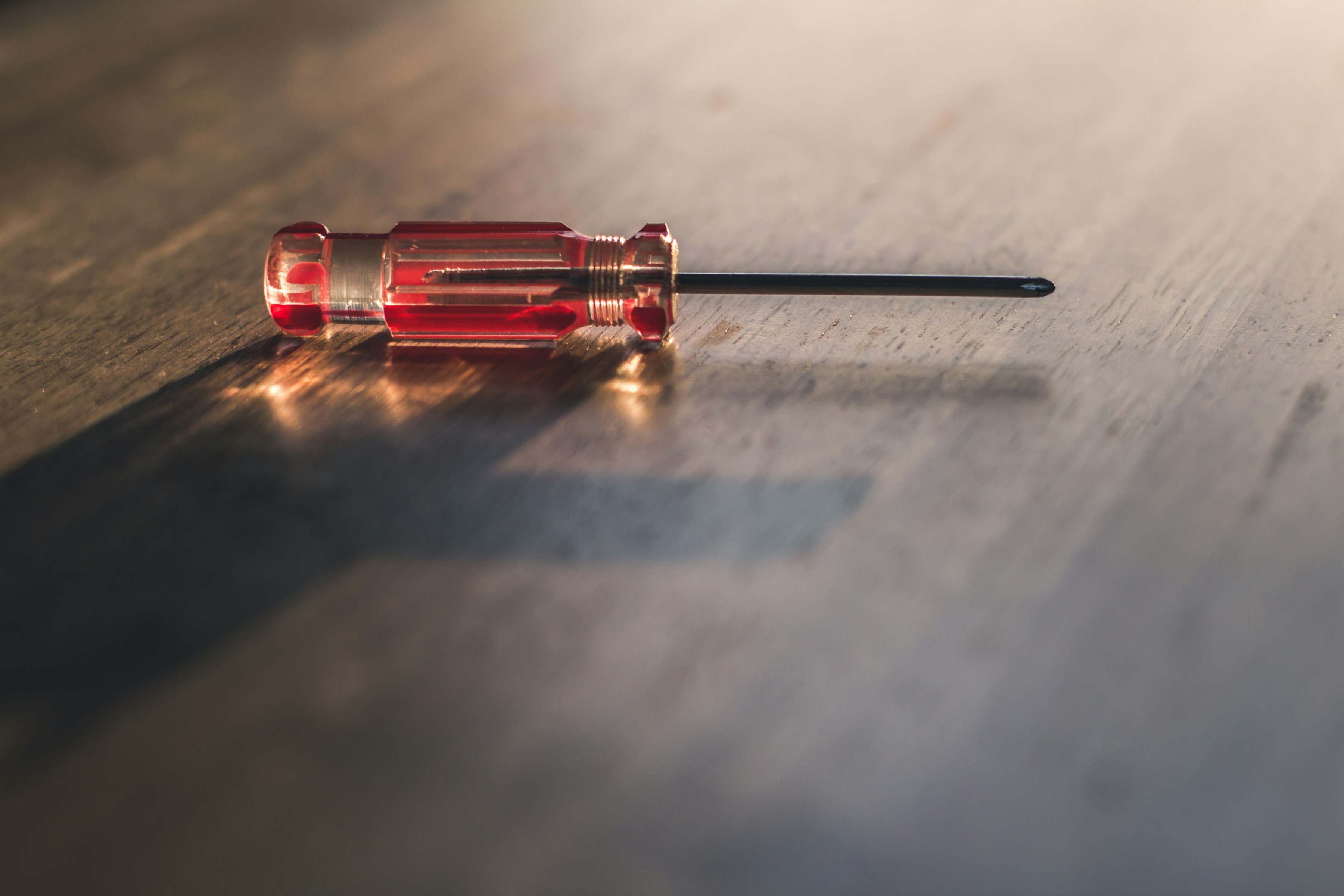 A small screwdriver on the workbench